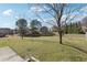 Large backyard with trees and a pond at 1309 Avington Glen Dr, Lawrenceville, GA 30045