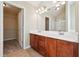 Well-lit bathroom with a double vanity, large mirror, and walk in closet at 1309 Avington Glen Dr, Lawrenceville, GA 30045