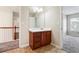 Bathroom with a vanity, mirror, and tile flooring, with an open doorway at 1309 Avington Glen Dr, Lawrenceville, GA 30045