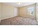 Bright and airy carpeted bedroom with natural light from window at 1309 Avington Glen Dr, Lawrenceville, GA 30045