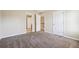 Bedroom with carpeted floor, two doors, and neutral paint at 1309 Avington Glen Dr, Lawrenceville, GA 30045