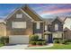 Charming brick home with a well-manicured front yard and attached garage at 1309 Avington Glen Dr, Lawrenceville, GA 30045