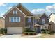 Charming two-story home with a well-manicured front yard and brick and stone facade at 1309 Avington Glen Dr, Lawrenceville, GA 30045
