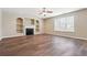 Bright living room with a fireplace, built-in shelving, and wood-look flooring at 1309 Avington Glen Dr, Lawrenceville, GA 30045