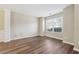 Bright living room with hardwood floors, large windows, and classic trim details at 1309 Avington Glen Dr, Lawrenceville, GA 30045