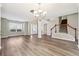 Open-concept living space with hardwood floors, chandelier lighting and staircase access at 1309 Avington Glen Dr, Lawrenceville, GA 30045