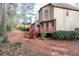 View of the rear exterior and deck area, complemented by a private backyard that merges with mature foliage creating a private oasis at 2552 Forest Meadow Ln, Lawrenceville, GA 30043