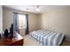 This bedroom features a twin bed, dark wooden dresser, light walls, and a window that provide a simple and comfortable space at 2552 Forest Meadow Ln, Lawrenceville, GA 30043