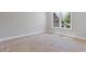 Neutral bedroom with a large window overlooking an adjacent home and mature trees at 304 Trecastle Ln # 28, Canton, GA 30114