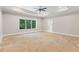 Spacious bedroom with trey ceilings, ceiling fan and a large window overlooking trees at 304 Trecastle Ln # 28, Canton, GA 30114