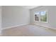 A well-lit bedroom with large windows, neutral walls, and ample space for furniture at 304 Trecastle Ln # 28, Canton, GA 30114
