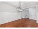 Dining room with wainscotting, hardwood floors and modern chandelier at 304 Trecastle Ln # 28, Canton, GA 30114
