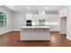 Bright kitchen with a large island, white cabinetry, stainless appliances, and hardwood flooring at 304 Trecastle Ln # 28, Canton, GA 30114