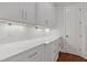 Spacious white kitchen with a long countertop, ample cabinetry, and convenient lighting at 304 Trecastle Ln # 28, Canton, GA 30114