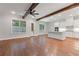 Spacious living room leading to the kitchen with hardwood floors and abundant natural light at 304 Trecastle Ln # 28, Canton, GA 30114