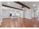 Open floor plan featuring hardwood floors, wood beams, and a kitchen with modern appliances at 304 Trecastle Ln # 28, Canton, GA 30114