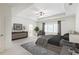 Bright main bedroom with tray ceiling, fan, neutral color palette, and window with natural light at 304 Trecastle Ln # 28, Canton, GA 30114