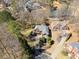 Aerial view of a house with mature landscaping, a long driveway, and a backyard pond at 511 Newburgh Way, Roswell, GA 30075