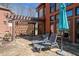 Back patio with pergola, stone patio with chairs for lounging with an umbrella at 511 Newburgh Way, Roswell, GA 30075