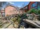 Backyard view featuring waterfall with koi pond and tiered landscaping and view of second house at 511 Newburgh Way, Roswell, GA 30075