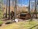 Backyard with play structure and storage shed surrounded by mature trees at 511 Newburgh Way, Roswell, GA 30075