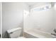 Guest bathroom with a tiled shower, toilet and small window at 511 Newburgh Way, Roswell, GA 30075