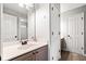 Bathroom featuring a single vanity, toilet, shower, and linen closet at 511 Newburgh Way, Roswell, GA 30075