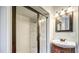 Bright bathroom featuring walk-in shower, vintage vanity and updated lighting fixtures at 511 Newburgh Way, Roswell, GA 30075
