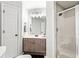 Bathroom with gray cabinets, a sink with a chrome faucet, shower with glass door and a commode at 511 Newburgh Way, Roswell, GA 30075