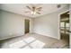 Bright bedroom featuring a ceiling fan and entry to walk-in closet at 511 Newburgh Way, Roswell, GA 30075