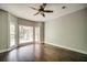 Bright bedroom with dark wood floors, ceiling fan, and large windows overlooking backyard at 511 Newburgh Way, Roswell, GA 30075