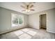 Bright bedroom with a large window offering ample natural light, neutral paint, and closet at 511 Newburgh Way, Roswell, GA 30075