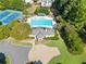 Aerial view of a luxurious community pool and clubhouse with mature trees at 511 Newburgh Way, Roswell, GA 30075