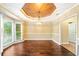 Elegant dining room features dark hardwood floors, chandelier, and large windows at 511 Newburgh Way, Roswell, GA 30075