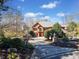 An elegant two-story home with a driveway and mature landscaping at 511 Newburgh Way, Roswell, GA 30075