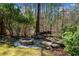 Inviting stone fire pit surrounded by lush greenery, perfect for outdoor gatherings at 511 Newburgh Way, Roswell, GA 30075
