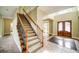 Welcoming foyer with staircase, tile entry and wood railing detail at 511 Newburgh Way, Roswell, GA 30075