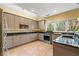 Modern kitchen with granite countertops, stainless steel appliances, and natural light at 511 Newburgh Way, Roswell, GA 30075