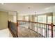 Open landing featuring carpet, wood and iron railing and natural light at 511 Newburgh Way, Roswell, GA 30075