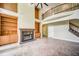 Open-concept living room features a fireplace, built-in bookshelves, and staircase at 511 Newburgh Way, Roswell, GA 30075