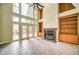 Bright living room with a fireplace, built-in shelving, soaring ceilings, and lots of natural light at 511 Newburgh Way, Roswell, GA 30075