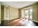 Bright living room featuring hardwood floors, built-in shelving, and large windows at 511 Newburgh Way, Roswell, GA 30075