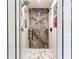 Luxurious glass shower showcasing marble-look tile and modern fixtures at 511 Newburgh Way, Roswell, GA 30075