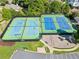 Aerial view of community tennis courts with lighting and a playground nearby at 511 Newburgh Way, Roswell, GA 30075