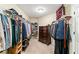 Spacious walk-in closet with extensive shelving, clothing rods, and a classic wood dresser at 511 Newburgh Way, Roswell, GA 30075