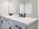 Modern bathroom features a double vanity with a quartz countertop, and a large mirror at 686 Smokey Quartz Way, Kennesaw, GA 30144