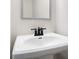 Classic white bathroom sink with matte black faucet and modern framed mirror at 686 Smokey Quartz Way, Kennesaw, GA 30144
