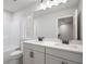 The bathroom has double sinks, white cabinets, a large mirror, and a bath and shower combination at 686 Smokey Quartz Way, Kennesaw, GA 30144