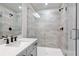 Modern bathroom features a gray-tiled shower with glass door and a single vanity at 686 Smokey Quartz Way, Kennesaw, GA 30144
