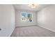 Bright bedroom features two windows, neutral carpet, and natural light at 686 Smokey Quartz Way, Kennesaw, GA 30144